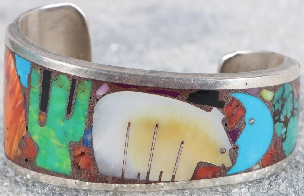 ZUNI FETISH SOUTHWEST STERLING GEMSTONE BRACELET: Zuni fetish bear southwest sterling silver inset gemstone ladies cuff bracelet with mother of pearl, turquoise, jasper, onyx, and more.Stone Type: AssortedWeight: 62.59 GramsSize: 7.5" lengthCondition