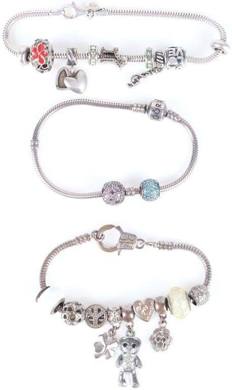 STERLING SILVER CHARM BRACELETS SIGNED PANDORA+ -3: Lot of three sterling silver charm bracelets, to include one Pandora bracelet, one Michael Anthony bracelet, and one unsigned bracelet.Weight: 71.91Condition: See pictures.