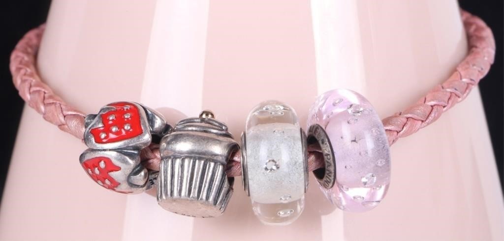 AUTHENTIC PANDORA LEATHER BRACELET W/4 CHARMS: Authentic Pandora pink leather bracelet with four charms. It comes with a sterling silver cupcake charm, the sterling silver sweet strawberry bead and 2 glass beads one is white and one is pink.Weight