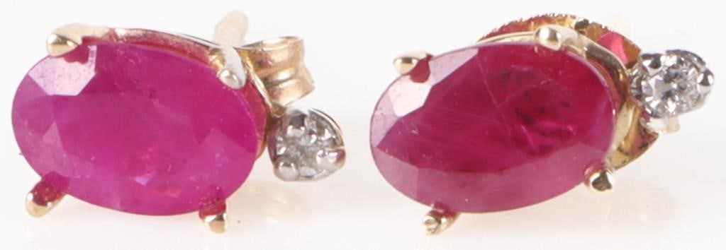 14K YELLOW GOLD RUBY & DIAMONDS LADIES EARRINGS: 14K yellow gold stud earrings, each of which have one oval-cut 0.2CT ruby gemstone and one melee diamond on top of it.Stone Type: RubySize: 8.4 mm tallCondition: Gently used. See images for complete c