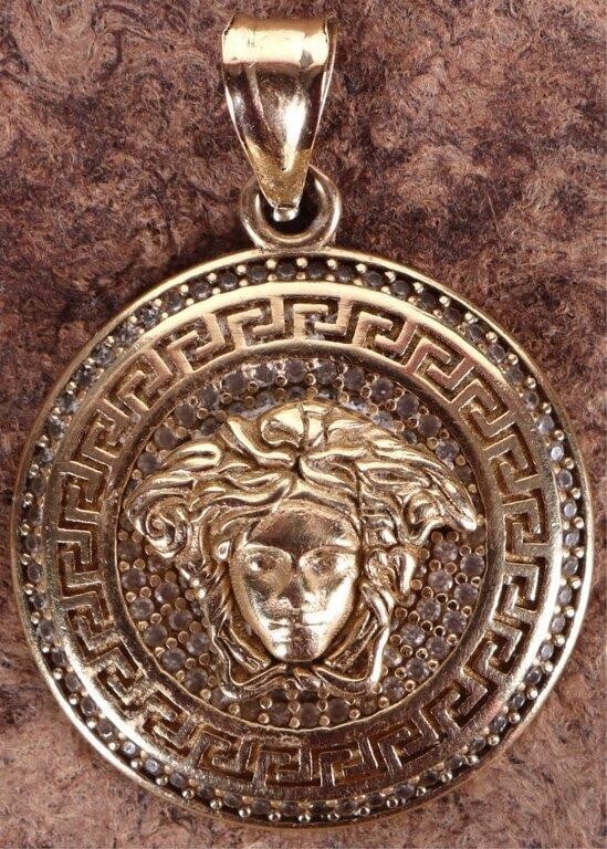 14K YELLOW GOLD VERSACE EROS MEDALLION PENDANT: 14K yellow gold Versace Eros crystal medallion pendant.Stone Type: AssortedWeight: 6.76 GramsSize: 1.375"Condition: Little wear, see images for details.