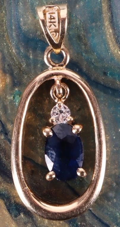 14K YELLOW GOLD OVAL SAPPHIRE FLOATING PENDANT: 14K yellow gold oval sapphire with an accent diamond floating pendant. The sapphire and diamond are set in a prong setting within an inner gold oval which is suspended within a slightly larger outer g