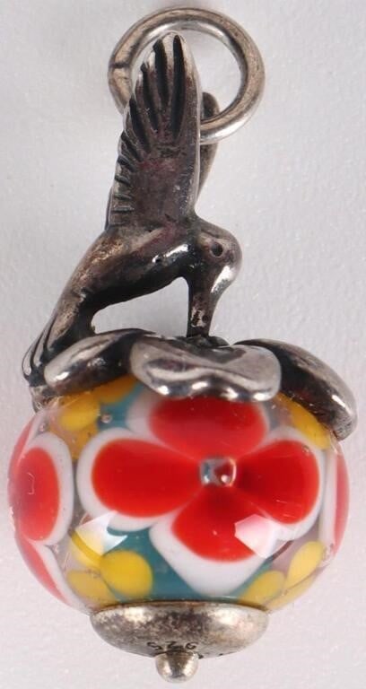JAMES AVERY STERLING ART GLASS HUMMINGBIRD CHARM: James Avery sterling silver retired art glass hummingbird finial bead charm. The hummingbird hovers over a sterling flower which rests atop the bead. The bead itself is covered in red and yellow flora