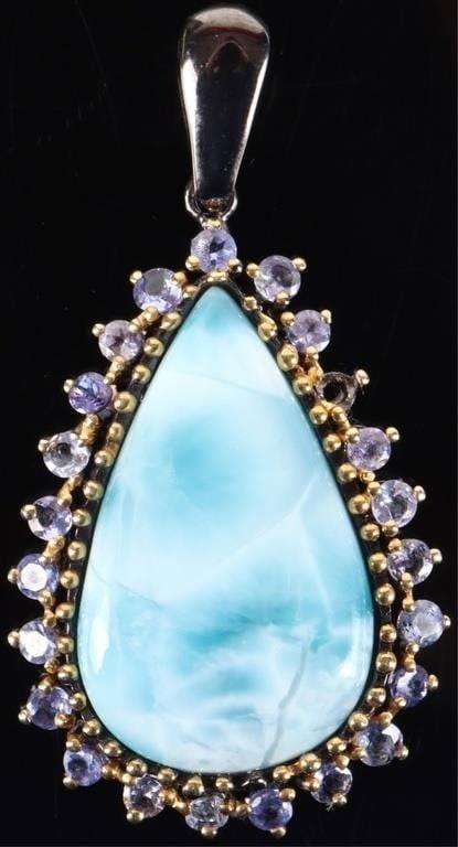 0.925 SILVER LARIMAR TANZANITE LADIES PENDANT: Sterling silver larimar tanzanite ladies pendant. Gemstones to include one 31.20mm X 19.00mm pear cabochon larimar and twenty-two 0.08ct round cut tanzanite.Stone Type: AssortedWeight: 13.42 GramsSize