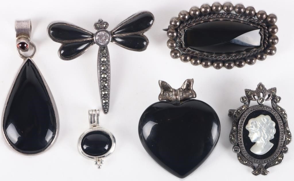 STERLING SILVER BLACK ONYX LADIES JEWELRY - (6): Sterling silver black onyx ladies jewelry to include one cameo brooch, one dragonfly brooch, one cushion-cut brooch, one heart pendant, one teardrop pendant, and one oval pendant.Stone Type:
