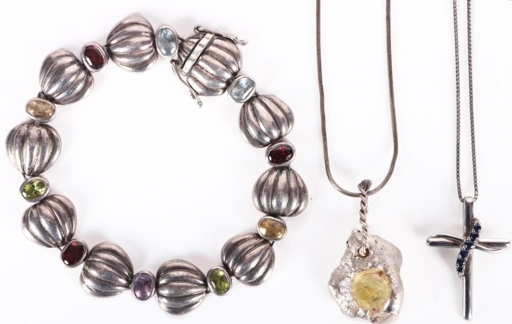 STERLING SILVER LADIES JEWELRY W/ GEMSTONES (3): Sterling silver ladies semiprecious gemstone jewelry. This lot includes a cross necklace with a band of blue sapphire gemstones (one 0.005ct, two 0.01ct, two 0.02ct, and one 0.03ct), a bracelet with