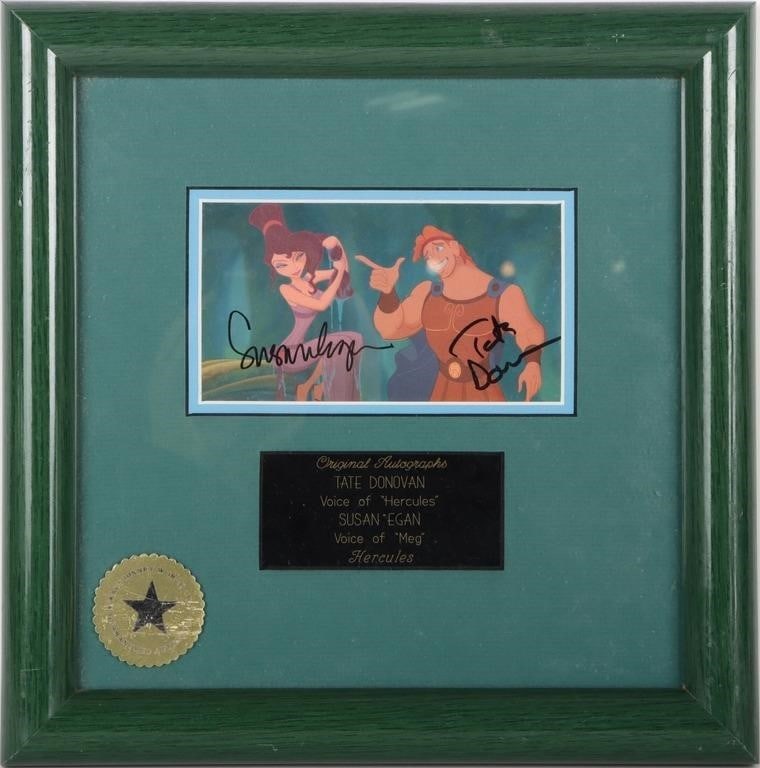 DISNEY HERCULES SIGNED TATE DONOVAN SUSAN EGAN PIC: Framed photograph of a scene from Disney's 'Hercules' with the signatures of Tate Donovan (voice of Hercules) and Susan Egan (voice of Meg). The frame is authenticated by Walt Disney World Co. and bea