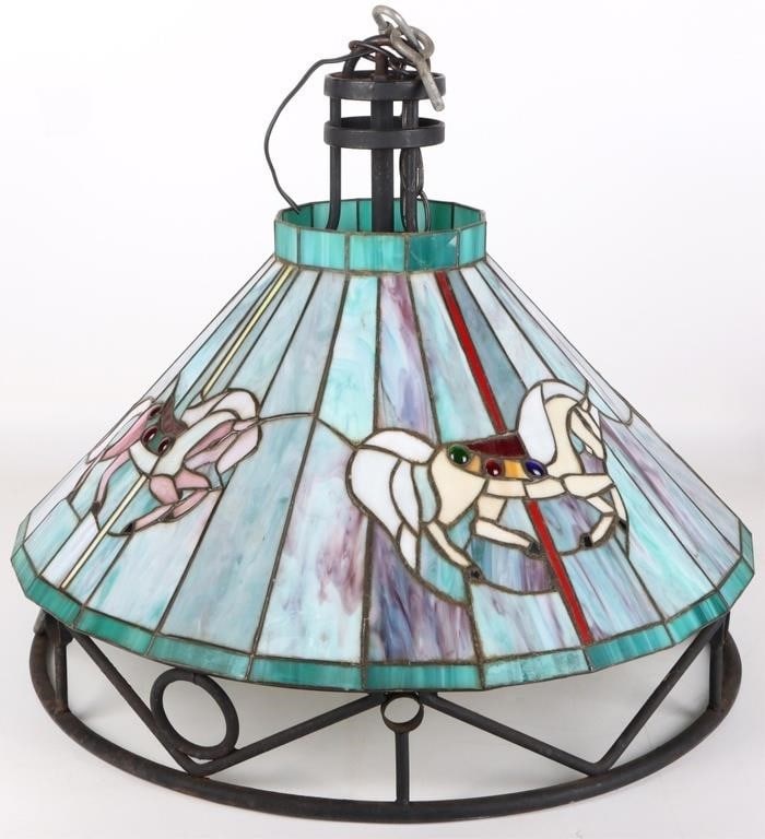 VINTAGE STAINED GLASS APPLEBEE'S HORSE CHANDELIER: Vintage stained glass wrought iron Applebee's horse light fixture chandelier. The lamp shade is adorned with carousel horses in various colors.Size: 20" x 17"Condition: Some cracks on lamp shade.