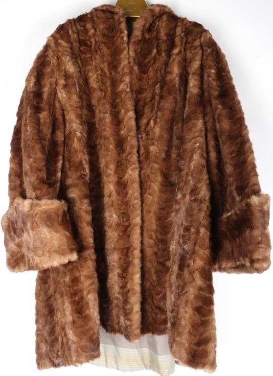LADIES MEDIUM BROWN MID LENGTH FUR COAT: Ladies medium brown mid length fur coat. This fur coat could be either mink or rabbit. Coat comes in a protective covering.Size: M-LCondition: No tears or fading. Please see images for complete