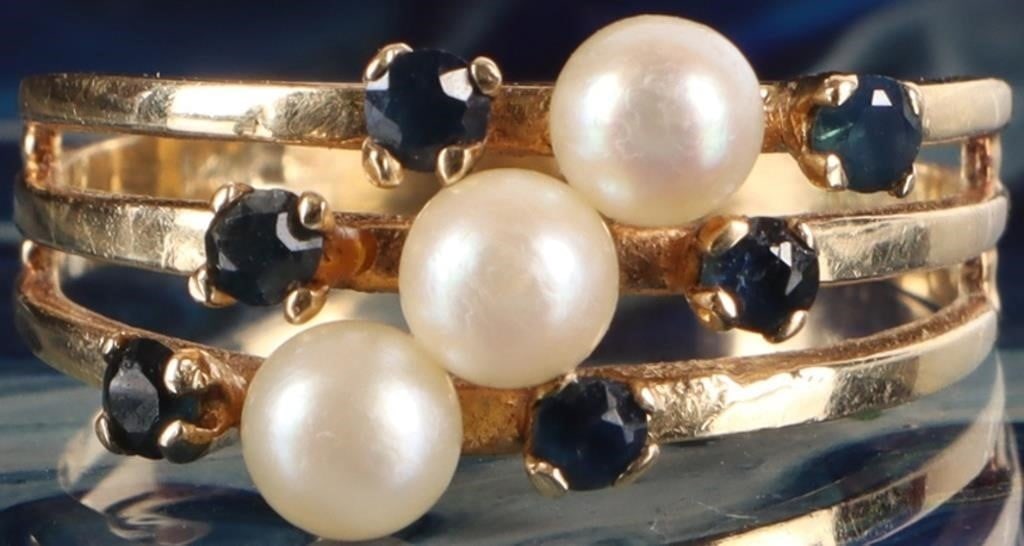 14K YELLOW GOLD BLUE SAPPHIRE PEARL LADIES RING: 14K yellow gold blue sapphire pearl ladies ring. Gemstones to include six 0.03ct round cut blue sapphire, and three 4.16mm pearls.Stone Type: AssortedWeight: 2.90 GramsSize: 7.25 U.S.Condition: Little