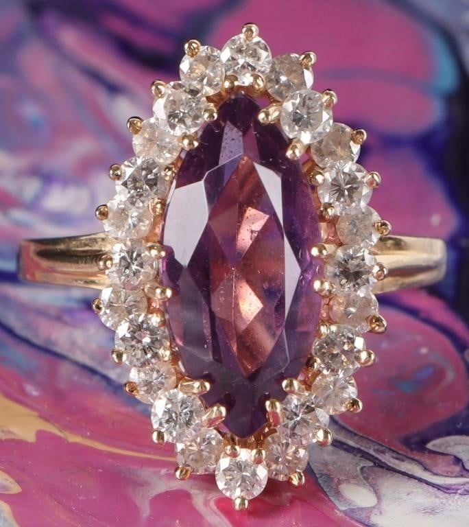 1.2CTW DIAMONDS 14K YELLOW GOLD LADIES RING W AMET: 14k yellow gold ladies ring with a 2.5ct marquise-cut amethyst center gemstone surrounded by twenty-four 0.05ct round-cut accessory diamonds.Stone Type: DiamondWeight: 5.05 gramsSize: US 6.5Condition: