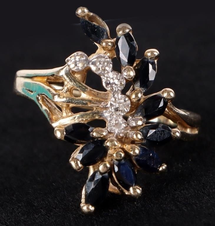 VINTAGE 14K MARQUISE CUT SAPPHIRE & DIAMOND RING: Vintage 14K yellow gold marquise cut sapphire & diamond ladies ring. The deep blue sapphires and accent diamonds are arranged in a cluster setting forming a floral or star burst- like design on the to