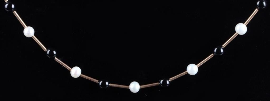 14K GOLD NECKLACE W/ FRESHWATER PEARLS AND BEADS: 14K yellow gold necklace with an alternating pattern of freshwater pearls and black beads connected by gold tubes.Stone Type: PearlWeight: 4.71 gramsSize: 17" longCondition: Very fine.
