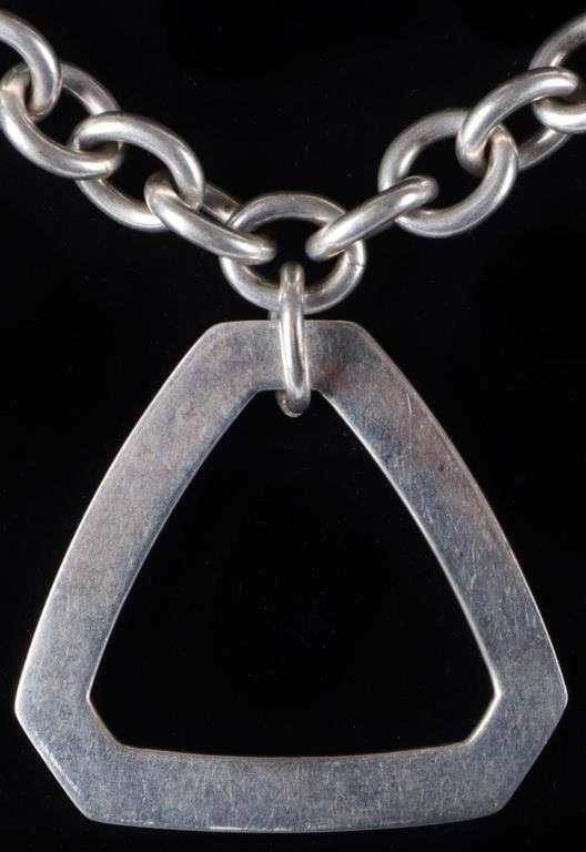 TIFFANY & CO STERLING SILVER LADIES CHAIN NECKLACE: Tiffany & Co. sterling silver ladies chain necklace with a large triangular pendant hanging from one of its links.Size: 18.5" longCondition: Like new, see pictures for more detail.