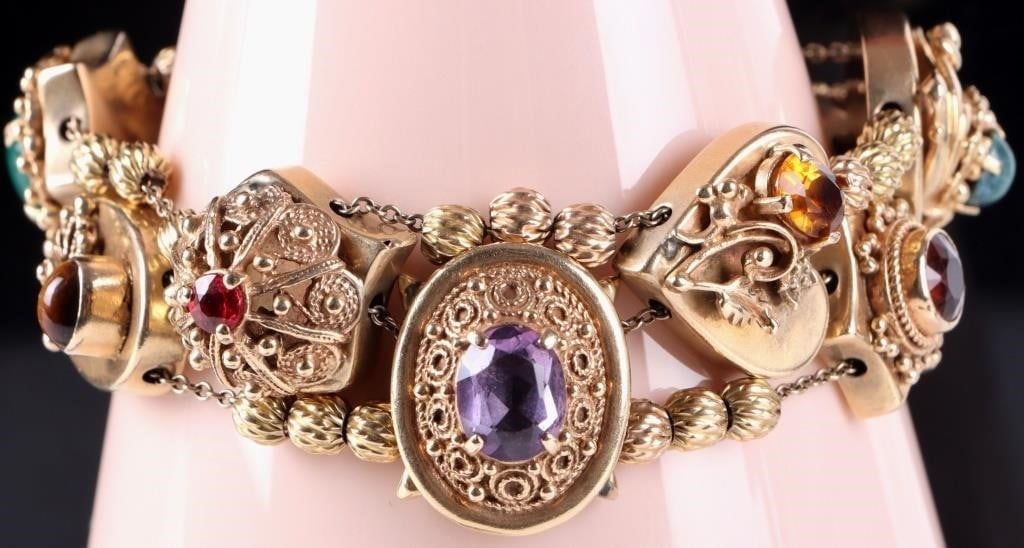 VINTAGE 14K YELLOW GOLD TRIPLE SLIDE BRACELET: Vintage 14k yellow gold triple slide bracelet with assorted gemstones to include jade, tiger's eye, amethyst, citrine, garnet, and coral. This bracelet has ten various-shaped charms.Stone Type: Assort