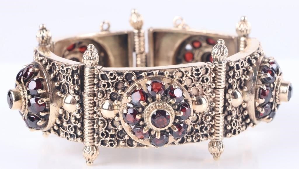 ANTIQUE GARNET 14KT GOLD PANEL BRACELET: Experience timeless elegance with this exquisite vintage panel bracelet. Crafted from rich 14k gold, this statement piece features five ornate, interconnected panels. At the heart of every panel lies