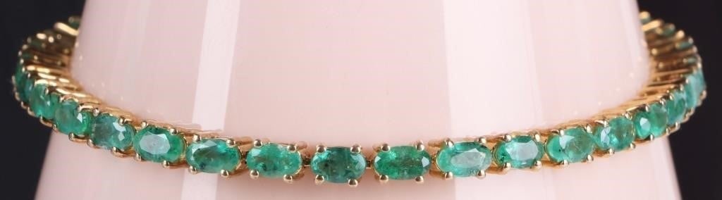 ~5.25CTW EMERALD LADIES STERLING TENNIS BRACELET: ~5.25CTW oval emerald ladies tennis bracelet set in gold tone sterling silver.Stone Type: EmeraldWeight: 11.99 GramsSize: 7"Condition: No missing stones. See images for complete condition.