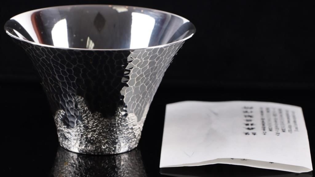 JAPANESE STERLING SILVER SAKE CUP MT FUJI THEMED: Japanese sterling silver Mt. Fuji-themed sake cup. The piece is detailed in such a way that it resembles a mountain when flipped upside down. Includes a care guide written in Japanese and a yellow sto