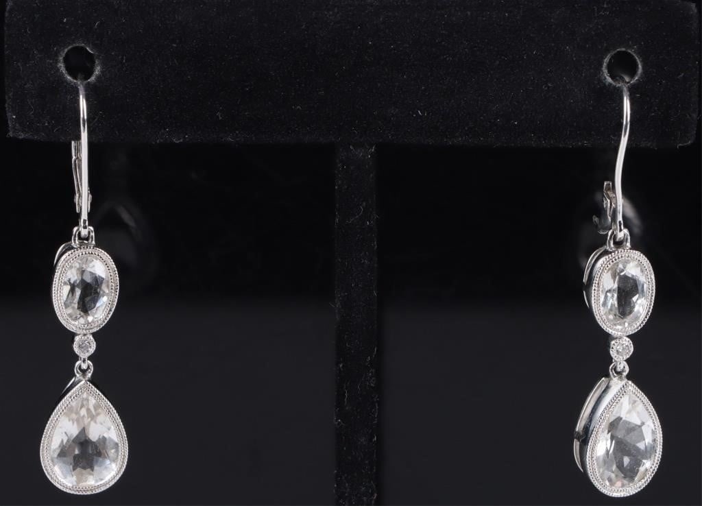 14K WHITE GOLD DIAMOND TOPAZ LADIES EARRINGS: 14k white gold diamond topaz ladies earring to include two 1.5ct teardrop topaz, two 1.0ct oval topaz, and two 0.02ct round diamonds.Stone Type: TopazWeight: 5.00 GramsSize: 1.5" LengthCondition: Clas