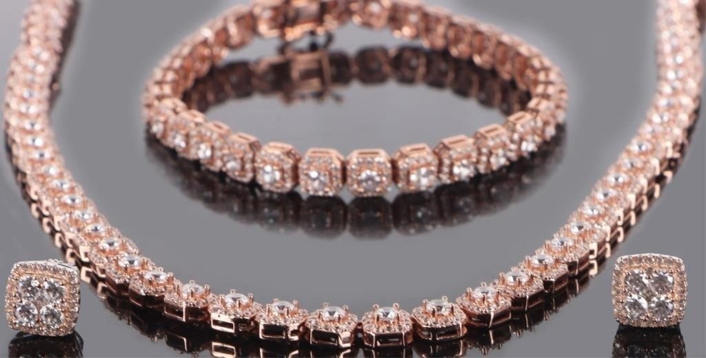 ROSE-GOLD-TONE STERLING JEWELRY SET RHINESTONES-3: Set of three rose-gold-toned ladies sterling silver jewelry, to include one necklace, one bracelet, and one pair of earrings. Each are studded with brilliant bright rhinestones. They are contained in