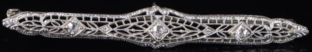 ANTIQUE ART DECO DIAMOND 14K WHITE GOLD PIN: Antique art deco diamond 14k white gold filigree ladies pin with one 0.07ct round diamond and two 0.04ct round diamonds.Stone Type: DiamondWeight: 3.23 gramsSize: 2.25" LengthCondition: Wear commensur