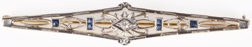 VINTAGE SAPPHIRE 10K BI-COLORED GOLD LADIES PIN: Vintage art deco sapphire 10K yellow and white gold ladies pin. Pin has one 0.05ct round white sapphire and several blue glass stones.Stone Type: SapphireWeight: 3.03 GramsSize: 2.5" lengthCondition: