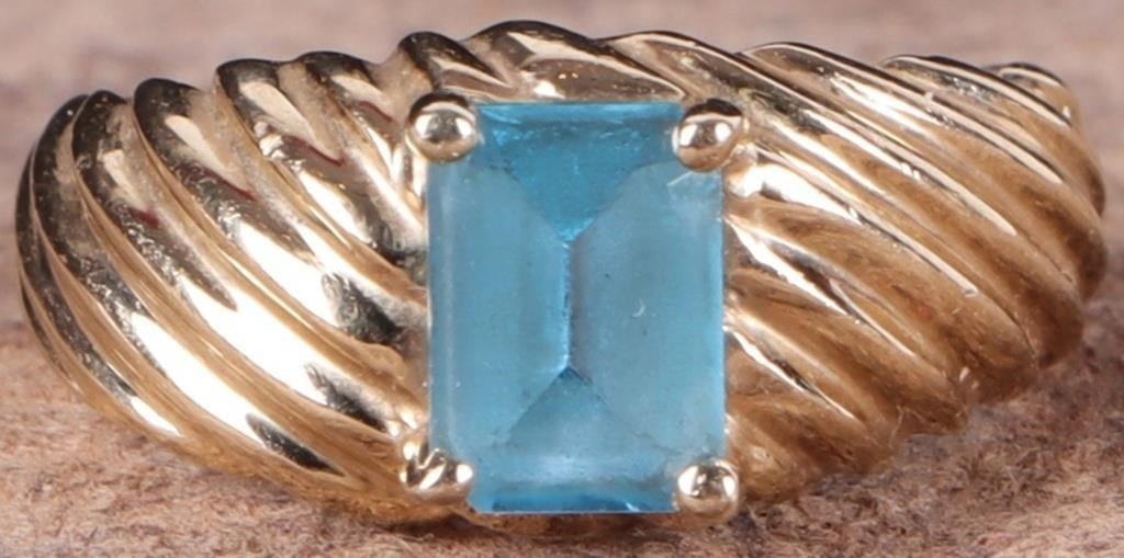 14K YELLOW GOLD BLUE TOPAZ LADIES RING: 14K yellow gold blue topaz ladies ring. Gemstones to include one 0.75ct emerald cut blue topaz.Stone Type: TopazWeight: 3.56 GramsSize: 4.75 U.S.Condition: Little to no wear, see images for details.