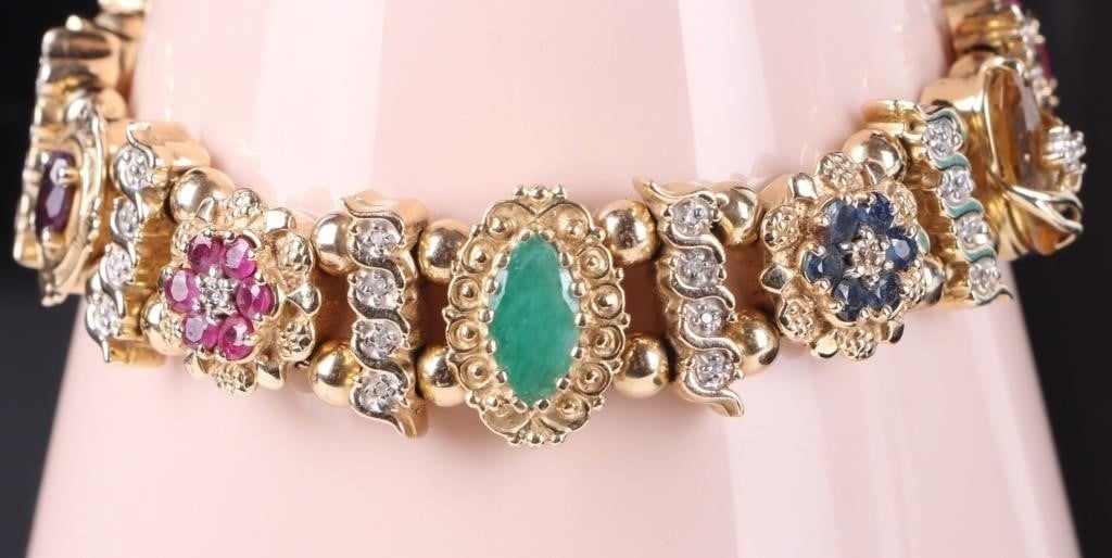 14K YELLOW GOLD MULTI GEMSTONE LADIES BRACELET: 14K yellow gold multi gemstone ladies bracelet. This stunning bracelet is adorned with rubies, emeralds, amethyst, opal, citrine, mystic topaz, blue topaz and diamond. This bracelet is very intricatel