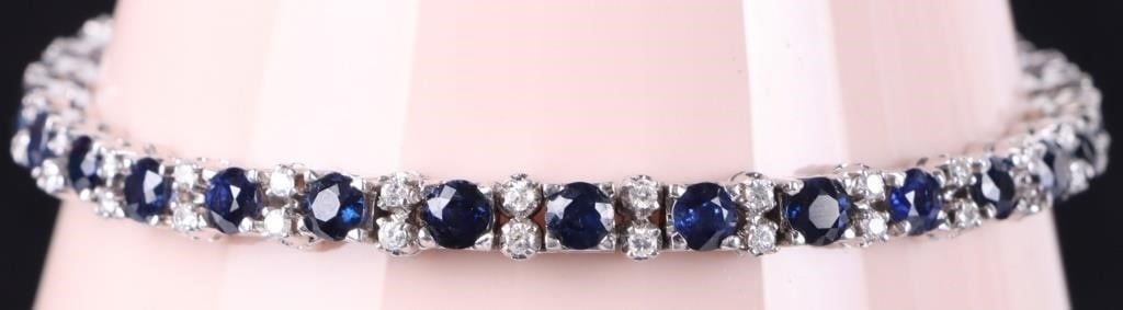 18K WHITE GOLD SAPPHIRE DIAMOND LADIES BRACELET: 18K white gold sapphire diamond ladies tennis bracelet. Gemstones to include twenty-nine 0.20ct round cut sapphire and fifty-eight 0.01ct round cut diamonds.Stone Type: AssortedWeight: 18.57 GramsSize