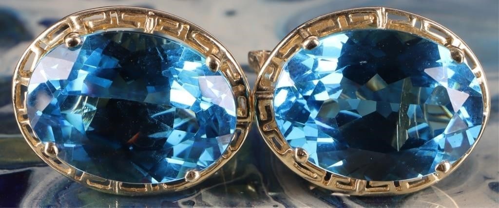 14K YELLOW GOLD LADIES EARRINGS W/ BLUE STONES: Pair of 14k yellow gold ladies earrings, each of which feature a large blue stone surrounded by a Greek meander motif.Size: 20.85 x 16.6 x 10 mmCondition: See pictures.