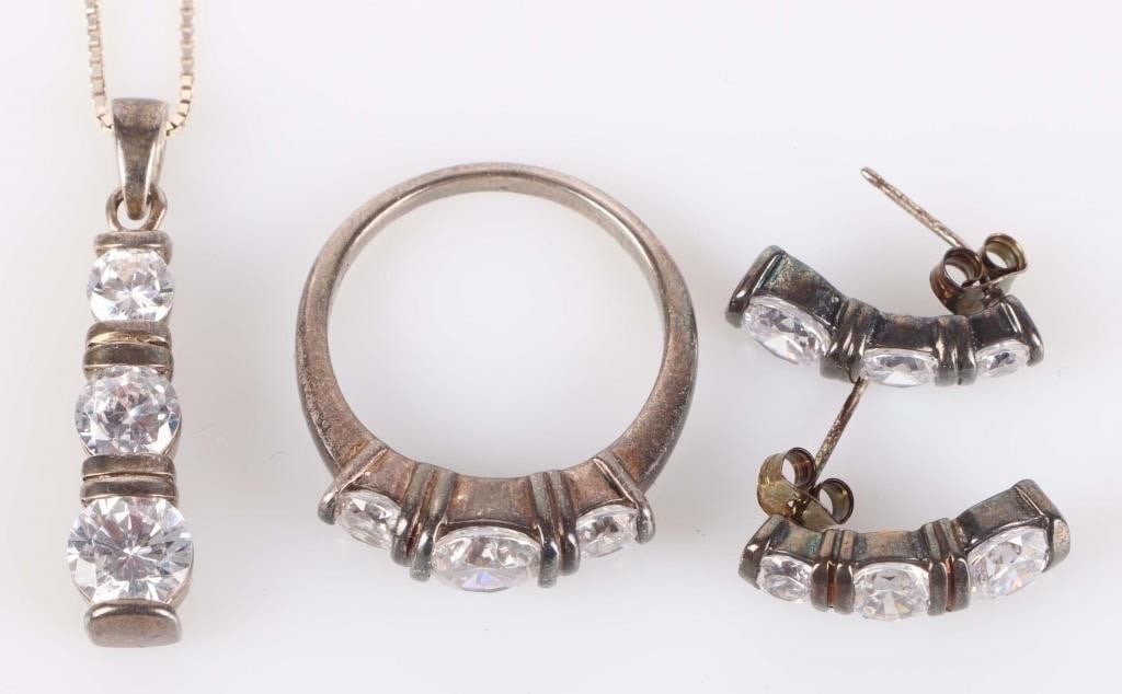 STERLING SILVER CZ LADIES JEWELRY SET: Sterling silver CZ ladies jewelry set to include: one size US 9.0 sterling silver CZ ring with one 1.00CT round cut CZ and two 0.33CT round cut CZ, a matching set of earrings, and a matching necklace.