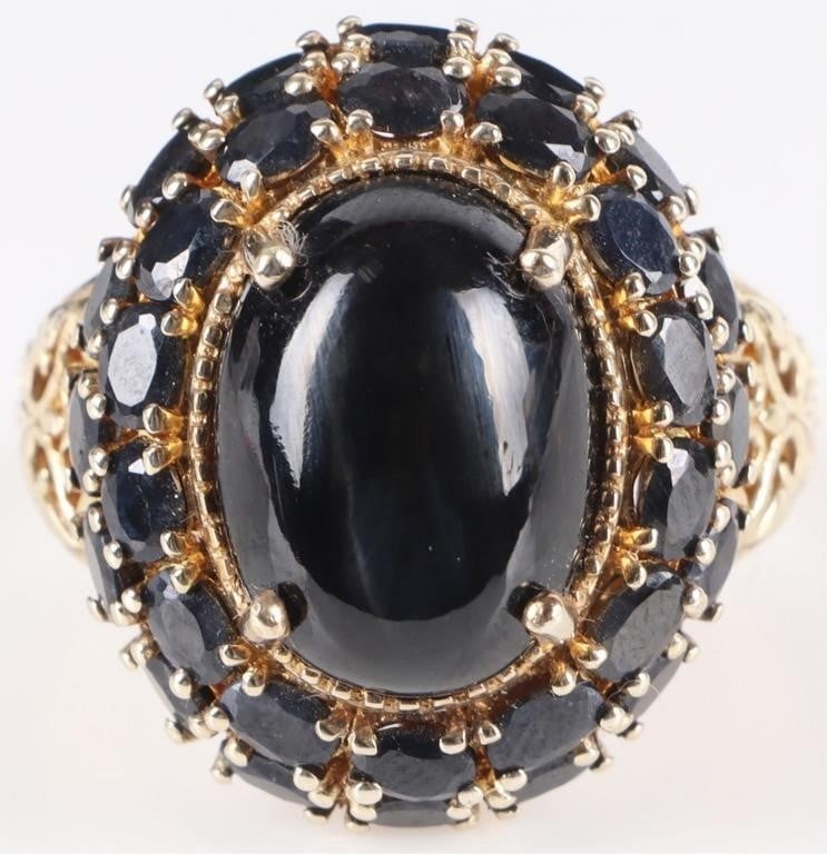 0.925 SILVER CHATOYANT ONYX SAPPHIRE LADIES RING: Sterling silver filigree chatoyant onyx sapphire ladies ring. Gemstones to include one 16.21mm X 11.82mm cabochon chatoyant onyx and thirty 0.10ct oval cut blue sapphire.Stone Type: AssortedWeight: