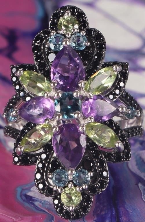 STERLING SILVER LADIES RING FLORAL TOPAZ PERID AME: Sterling silver ladies ring with multiple gemstones arranged in a floral pattern, to include seven round-cut topaz gems (one 0.33ct center stone, four 0.1ct stones, and two 0.01ct stones), six