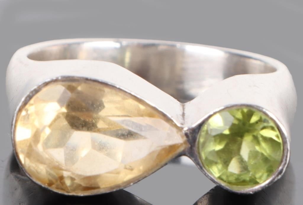 CITRINE & PERIDOT STERLING SILVER RING: Citrine & peridot sterling silver ring. Citrine is a 2Ct pear shaped & peridot is 1Ct round cut.Stone Type: CitrineWeight: 8.77 GramsSize: 8.0Condition: Very Fine