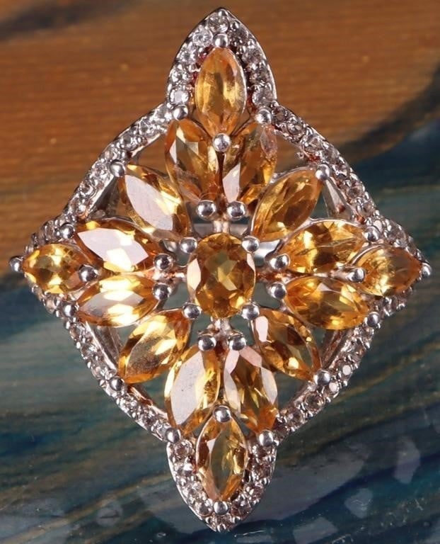 ORNATE STERLING CITRINE & WHITE TOPAZ LADIES RING: Ornate sterling silver citrine and white topaz ladies cocktail ring. This beautiful ring features a star shaped design made up of numerous faceted citrine. The central stones are surrounded by a