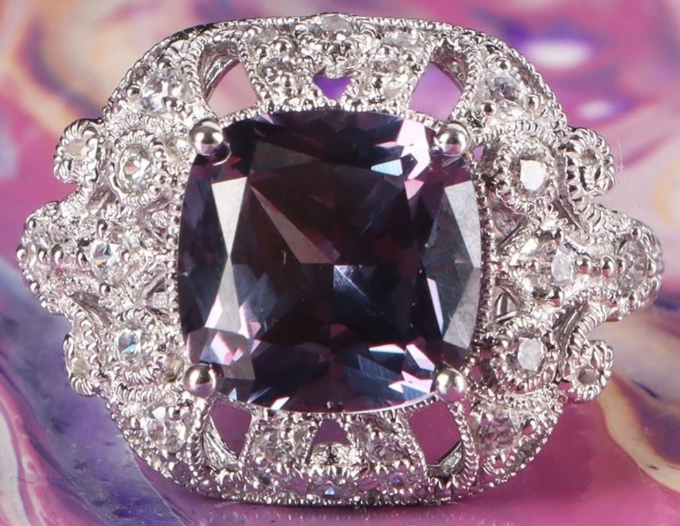 3CT BICOLOR CUSHION CUT SAPPHIRE HALO LADIES RING: 3CT bicolor cushion cut sapphire halo ladies ring set in sterling silver. The sapphire is surrounded by a very intricately detailed halo of small white gemstonesStone Type: SapphireWeight: 5.46