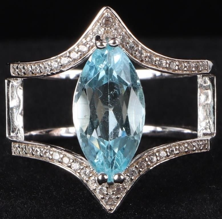 2CT MARQUISE TOPAZ STERLING SILVER LADIES RING: Sterling silver ladies ring with a 2ct marquise-cut topaz center gemstone and small simulant diamonds lining the shoulders.Stone Type: TopazWeight: 4.71 gramsSize: US 7.25Condition: See pictures.