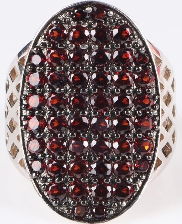 925 BBJ GARNET OVAL CLUSTER COCKTAIL LADIES RING: 925 garnet oval cluster cocktail ladies ring. This ring has 10 rows of garnet close together to cover the entire surface. The sides of the ring resemble lattice creating a beautiful open design. The