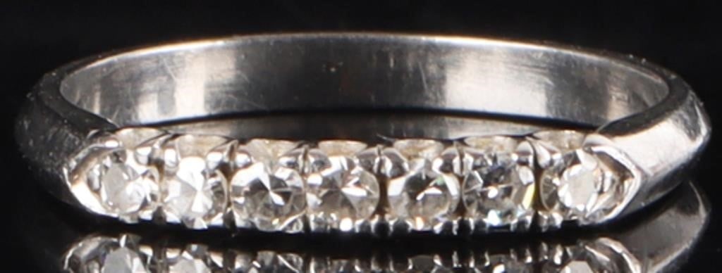 DAINTY PLATINUM DIAMOND LADIES WEDDING BAND: Dainty platinum ladies wedding band. This wedding band has seven small pave set diamonds along the top of the band. The style is classic and versatile, designed to be worn alone or stacked with an eng