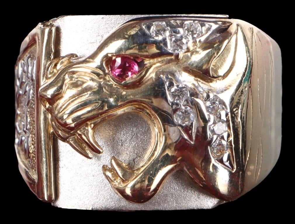 10K YELLOW/WHITE GOLD MENS PANTHER RING W/ RUBY: 10k yellow/ white gold mens ring. There is a snarling yellow gold panther sculpted on the face against a white gold background. Its visible eye is a small ruby gemstone while cubic zirconium is cluste