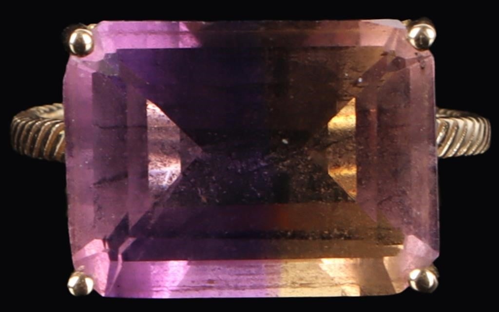 15CT AMETRINE 10K YELLOW GOLD LADIES RING: 10k yellow gold ladies ring with a 15ct rectangle-cut Ametrine center gemstone.Stone Type: SpinelWeight: 4.46 w/ spinelSize: US 8Condition: There are cracks present on the galleries, see pictures for