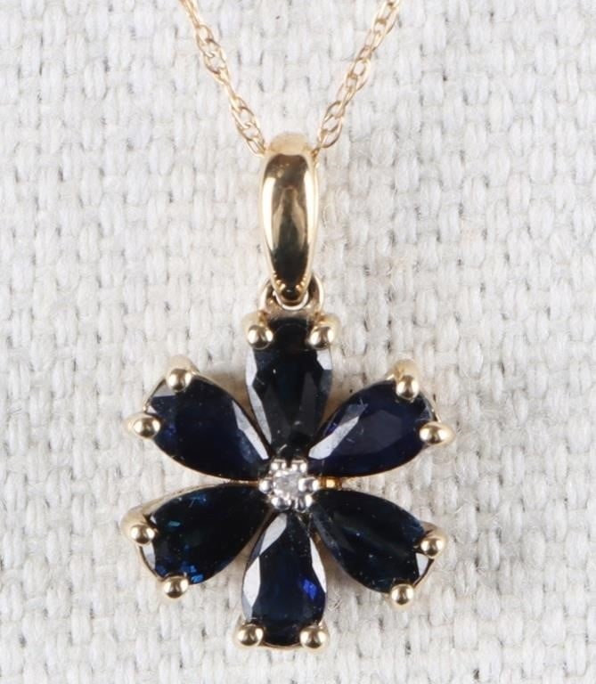 10K YELLOW GOLD LADIES NECKLACE W/ DIAMOND & SAPPH: 10k yellow gold ladies necklace with a floral pendant. The petals are composed of six 0.1ct marquis-cut blue sapphire gemstones and the center features a melee diamond.Stone Type: Diamond &
