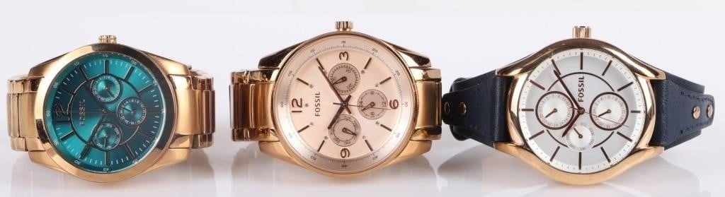 FOSSIL COLLECTIBLE LADIES WRISTWATCHES - (3): Fossil collectible ladies wristwatches to include one teal and gold toned watch (BQ1689), one blush pink watch (BQ1073), and one white Fossil gold toned watch with a leather band (BQ3138). Fossil Ladi