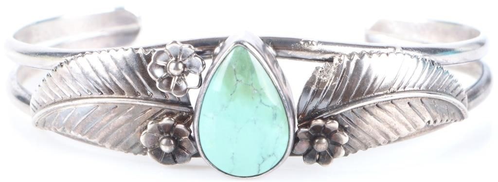 REFINED STERLING SILVER LADIES BRACELET W/ HOWLITE: Sterling silver ladies bracelet with a pear-cut howlite center stone flanked by two sterling leaves (one on each side) and four flowers (two on each side, at least in theory, as the top-right flower i