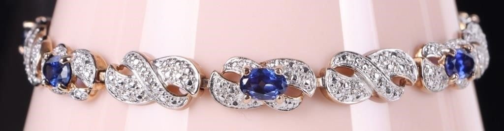 1.5CTW SAPPHIRE GOLD-TONE 925 LADIES BRACELET: Sterling silver ladies bracelet with six 0.25ct oval-cut sapphire gemstones set along the band (1.5ctw). The surface of the links are silver-toned and the bottom of the bracelet is gold-toned.Stone Ty