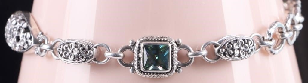 SARDA STERLING LADIES BRACELET W/ MYSTIC TOPAZ: Sarda sterling silver ladies bracelet molded in a fantastical style. The face, multiple brackets and the clasp feature clusters of rosettes. Two of the brackets feature 1ct square diamond cut mystic t