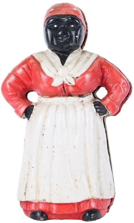 ANTIQUE AUNT JEMIMA CAST IRON COIN BANK FIGURE: This antique cast iron Aunt Jemima figure serves as both a coin bank and a door stop, measuring at a large 11 inches in size. The piece was created during the years 1900-1949, showcasing a primitive,