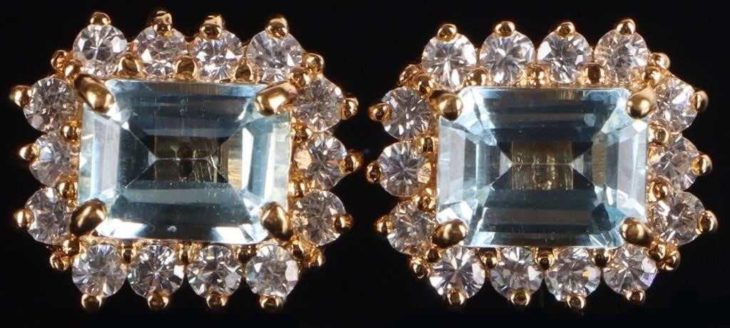 GOLD-TONE STERLING SILVER LADIES EARRINGS W/ TOPAZ: Pair of gold-tone sterling silver ladies earrings, each of which feature a 1ct baguette-cut topaz center gemstone surrounded by cubic zirconium accessory stones.Stone Type: TopazSize: 13.5 x 11.5 mmCo