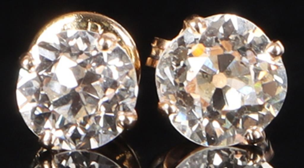 14K YELLOW GOLD LADIES STUD EARRINGS W/ DIAMOND: 14k yellow gold ladies stud earrings with diamond. One features a 0.5ct round-cut diamond and a 14k white gold push back, while the other features a 0.75ct round-cut diamond with a non-gold push back.