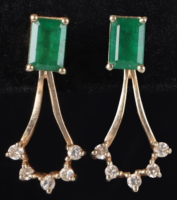 14K YELLOW GOLD LADIES EARRINGS W/ EMERALD & DIAS: 14k yellow gold ladies stud earrings. The main section features a 0.21ct baguette-cut emerald gemstone while a dangling section features five small synthetic diamonds.Stone Type: Emerald & DiamondsWei